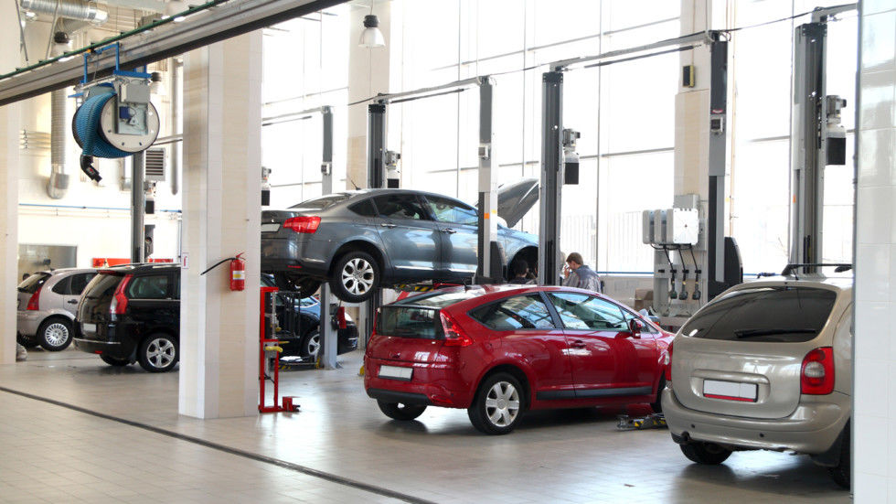 The image of car-care workshop and cars near the lifts