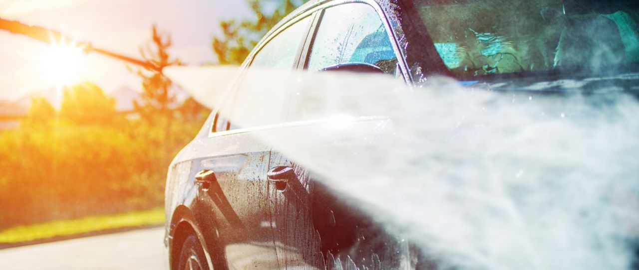 Summer Car Washing. Cleaning Car Using High Pressure Water.