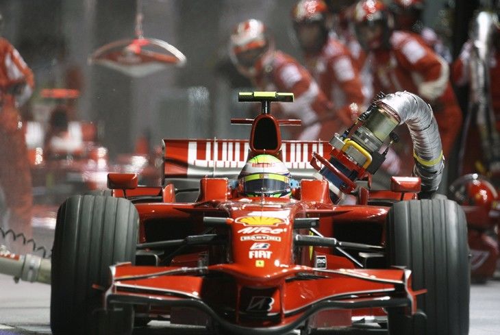Ferrari Formula One driver Felipe Massa of Brazil drives off with the fuel hose still attached...