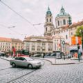 Car cross the tram tracks on the street Malostranske namesti in